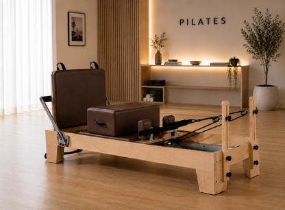 brown studio reformer with oakwood frame in. a sophisticated h9ome design, built for luxury wellness spaces.